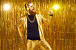 © Studio Romantic - Happy eccentric redhead man wearing crazy suit, gold neck chain and stylish wireless headphones enjoying free unlimited online music, listening to favorite audio track, singing, dancing and having fun