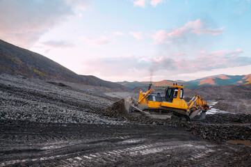 Wall Mural - Bulldozer in  process of working in an industrial mountain area