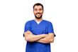 © Syda Productions - healthcare, profession and medicine concept - happy smiling doctor or male nurse in blue uniform with crossed arms over white background
