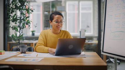 Aufkleber - Portrait of Young Latin Marketing Specialist in Glasses Working on Laptop Computer in Busy Creative Office Environment. Beautiful Diverse Multiethnic Female Project Manager is Browsing Internet.