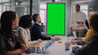 © Gorodenkoff - Project Manager Makes a Presentation on a Green Screen Mock Up Display for a Young Diverse Creative Team in Meeting Room in an Agency. Colleagues Sit Behind Conference Table and Discuss Business.