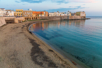 Poster - Italy, Apulia, Province of Lecce, Gallipoli. Beach and old town section over the Ionian Sea at sunset.