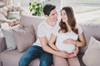 © deagreez - Portrait of nice affectionate perfect couple soulmates waiting newborn child caressing tummy in light house flat indoor