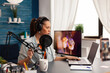 © DC Studio - Creative vlogger making online conversation with her audience for new concept vlog. Recording social media content with production headphones, digital web internet streaming station
