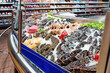 Fresh fish and seafood on iced market display, toned