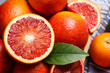 © New Africa - Whole and cut ripe red oranges with green leaf, closeup