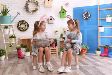 adorable little girls with bunny ears in easter photo zone