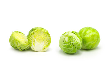 Fresh organic brussels sprouts whole and halves isolated on white background.	