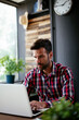 © JustLife - Young businessman working on laptop at office. Businessman sitting at office desk working on new project.