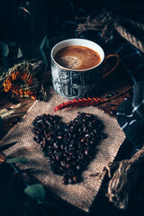 Coffee Beans in heart shape with cup of fresh coffee