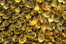 Bunch Of Fish Oil Capsules As Background.