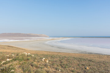 Koyash pink lake in the Crimea in the summer. Amazing delicate pastel landscape. The concept of relaxation, tranquility, and peace. Natural background in light neutral shades for design, layouts.