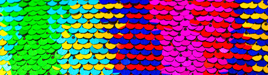 Wall Mural - Multicolored shiny sequins. Fabric with sequins as a background. Glittery texture is the trend of the season. Sparkling holographic blue, pink neon color.