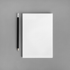 Wall Mural - Blank copybook and pencil on gray paper background. Branding ID template. Flat lay.