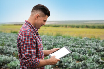 Man using tablet in field. Agriculture technology