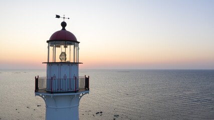 Poster - Lighthouse on the Kihnu island in Estonia during a beautiful sunset