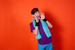 © Denis - Funny young man and retro style. Sports and recreation. Bright colors. Orange background.