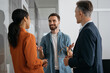 © ARUTA Images - Business people talking, planning start up, having meeting in modern office. Portrait of successful man developer communication with colleagues. Teamwork, brainstorming concept