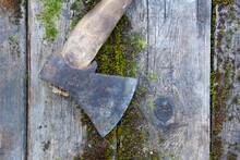  Vintage Axe With Wooden Handle On Antique Moss Boards Close Up. High Quality Photo