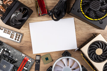 Fototapete - modern desktop computer hardware components wood desk table with blank copy space paper background. Circle shaped pc parts like cpu motherboard graphics card and ssd wood technology concept.