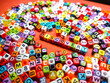 © Mohd Azrin - Selective focus.Colorful dice with word DISCOVERY on red background.Shot were noise and film grain.