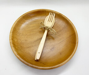 wooden plate and fork isolated on white background