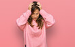 © Krakenimages.com - Young hispanic woman wearing casual clothes suffering from headache desperate and stressed because pain and migraine. hands on head.