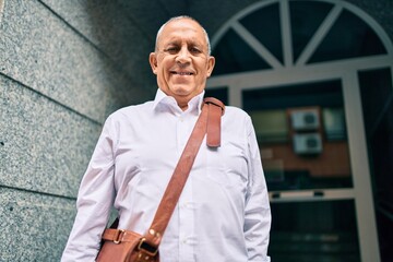 Wall Mural - senior businessman smiling happy walking at the city.