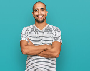 Poster - Hispanic adult man wearing casual clothes happy face smiling with crossed arms looking at the camera. positive person.