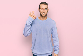 Sticker - Young caucasian man wearing casual clothes smiling positive doing ok sign with hand and fingers. successful expression.