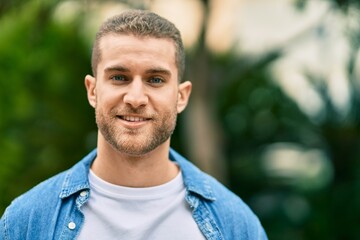 Sticker - Young caucasian man smiling happy standing at the park.