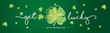 Get Lucky on St Patrick's Day white handwritten typography lettering line design four leaf clover and many small clovers on dark green background banner