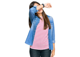 Poster - Young brunette woman wearing casual clothes covering eyes with arm smiling cheerful and funny. blind concept.