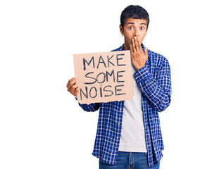 Sticker - Young african amercian man holding make some noise banner covering mouth with hand, shocked and afraid for mistake. surprised expression