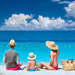 Wall Mural - Family on beach. Toddler playing with mother and father.