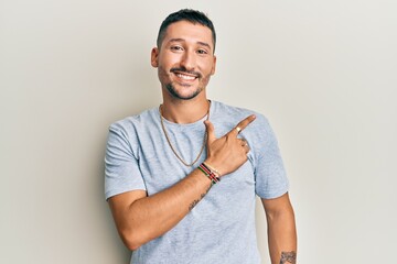 Sticker - Handsome man with tattoos wearing casual 90s style and gold chain smiling cheerful pointing with hand and finger up to the side