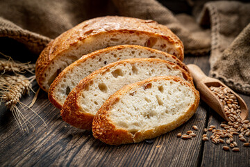 Freshly baked traditional bread on wooden table.