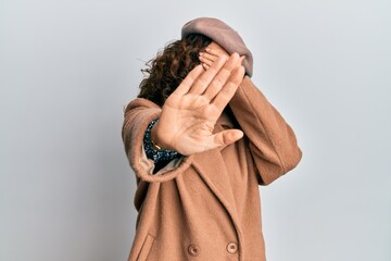 Canvas Print - Middle age hispanic woman wearing french look with beret covering eyes with hands and doing stop gesture with sad and fear expression. embarrassed and negative concept.