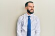 © Krakenimages.com - Young man with beard wearing business tie looking away to side with smile on face, natural expression. laughing confident.