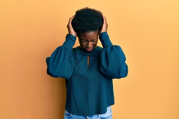 Wall Mural - Young african american girl wearing casual clothes suffering from headache desperate and stressed because pain and migraine. hands on head.