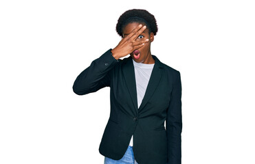 Sticker - Young african american girl wearing business clothes peeking in shock covering face and eyes with hand, looking through fingers with embarrassed expression.