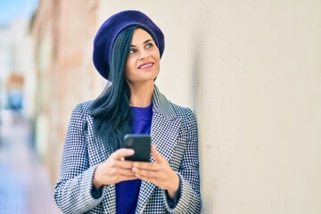 Wall Mural - Young beautiful woman wearing french style using smartphone at the park.