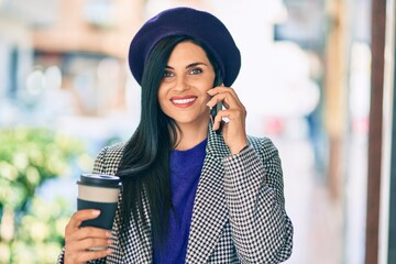 Wall Mural - Young beautiful woman wearing french style talking on the smartphone at the city