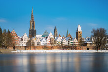 City Ulm With River Danube In Winter At Sunrise With Blue Sky And Snow. Ulmer Minster And Tower Metzgerturm. Panorama Long Exposure. Travel, Vacation