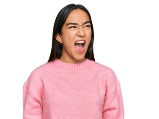 Poster - Young asian woman wearing casual winter sweater angry and mad screaming frustrated and furious, shouting with anger. rage and aggressive concept.