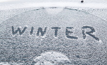 Word Winter Handwritten On Snowy Car Window At Winter Morning Light