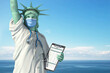 © Maksym Yemelyanov - Healthcare system inUSA United States concept. Statue of Liberty as doctor in medical gown with  surgical mask, stethoscope and medical analysis.