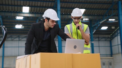 Wall Mural - Two factory workers working and discussing manufacturing plan in the factory . Industry and engineering concept .