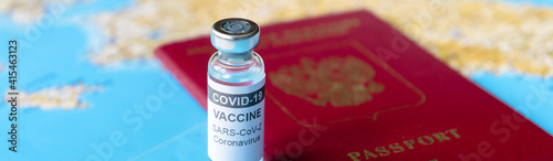 Obraz Dibond Panoramic banner with bottle of COVID-19 vaccine and passport on tourist map