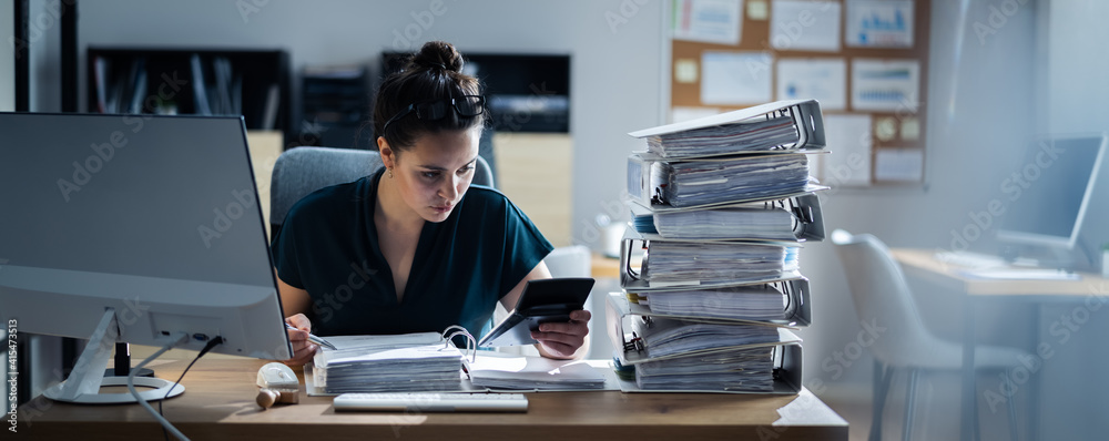 Young Businesswoman Working At Office With Stack Of Folders - obrazy, fototapety, plakaty 